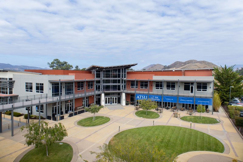The ATSU campus courtyard at 651 Tank Farm Road, with the hills behind